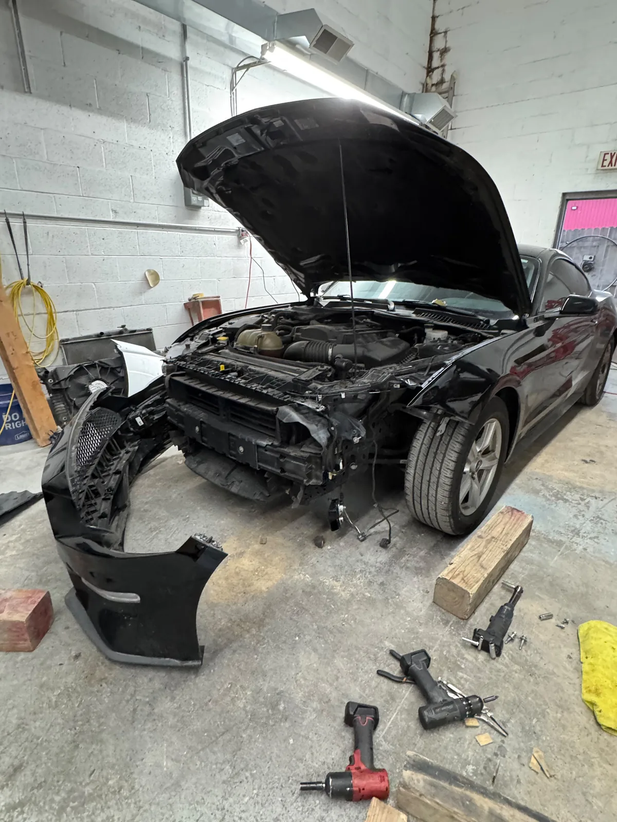 Car with front body panels removed during collision repair