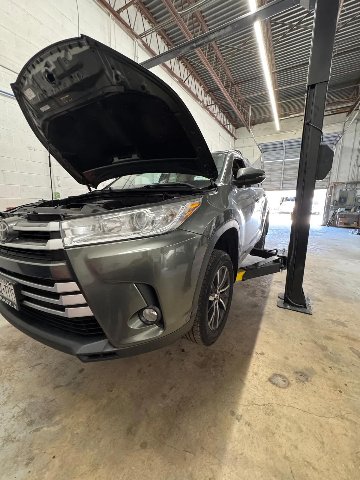 SUV in the Drive One workshop with its hood open